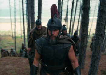 Odysseus and his army traverse through a sparse island forest