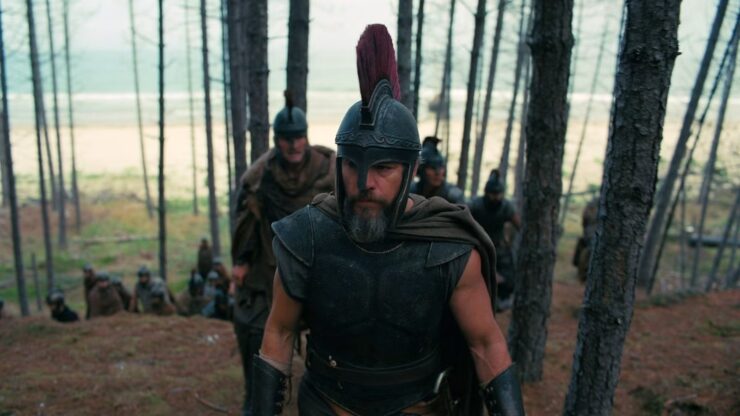 Odysseus and his army traverse through a sparse island forest