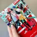 A hand holding volume 1 of the manga Our Not So Lonely Planet Travel Guide