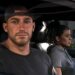 A screenshot of the GTA 6 Extended Look. Jason looks out a car window while sitting next to Lucia.
